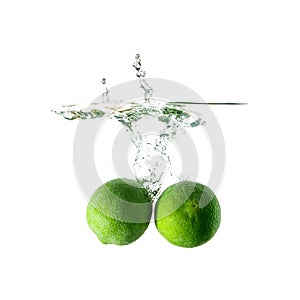 Limes splash on water on white background