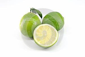 Limes, two wholes with leaf and one halved