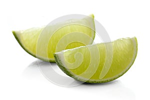 Limes on white background - close-up