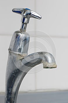 Limescale. Close-up of hard water calcium deposit on faucet tap