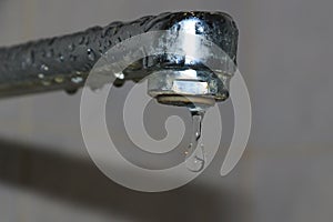 Limescale coating on plumbing. Water dripping from a faucet photo