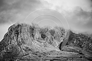 Limestone cliff detail in Rimetea whit clouds on balck and white