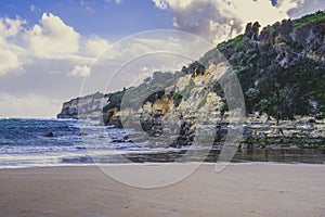 Limestone cliffs over ocean waves.