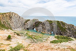 Limestone Foldings on Stair Hole Chalk Cliffs and Atlantic Ocean photo