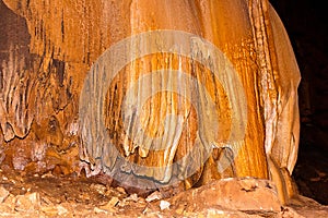 Limestone formations on the wall of an underground cave.