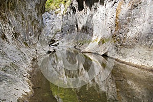 Limestone gorge river in mountains photo