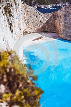 Limestone huge cliff rocks surrounding Navagio beach with Shipwreck and azure blue sea water. Zakynthos island, Greece