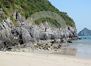 Limestone island beach in the sea bay