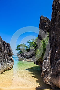 Limestone large rocks on Bagieng Island beach, Caramoan, Camarines Sur Province, Luzon in the Philippines. Vertical view