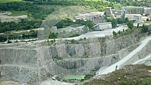 Limestone mine Stramberk mountain Kotouc pit with quarry machinery takes extracted open-pit trucks machines. Cement