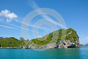 Limestone mountain on the sea in blue sky cloud sunny day