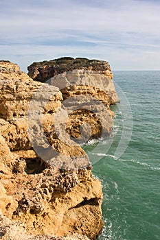 Limestone rock cliffs next to the ocean in Portugal