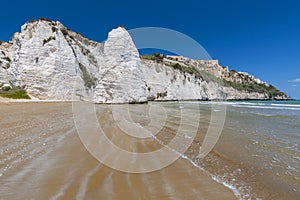 Limestone rock monolith and cliffs by the beach, Vieste, Gargano, Apulia, Italy