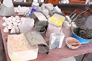 limestone work pieces for sculpturing with brushes and paint closeup photo