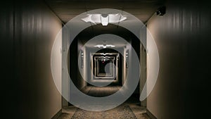 Long Empty Hotel Corridor with Overhead.