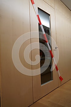Limited access to library premises due to coronavirus  and cover-19 crisis. Restricted area is marked with barrier tape. photo