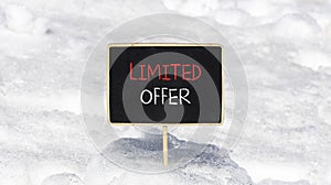 Limited offer symbol. Concept words Limited offer on beautiful black chalk blackboard. Beautiful white snow background. White snow