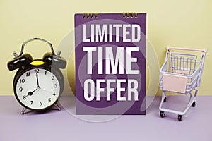 Limited Time Offer text with alarm clcok and trolley shopping cart on yellow background, Business concept background