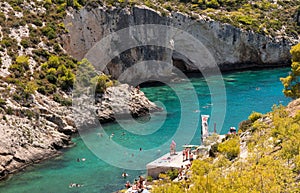 Limnionas beach in Zakynthos island in Greece with local people and tourists enjoying summer.