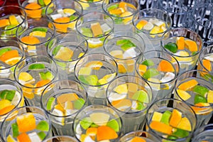 Limonade in glasses, orange and lime in fress water