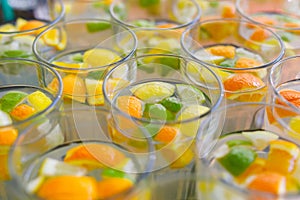 Limonade in glasses, orange and lime in fress water