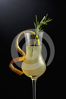 Limoncello garnished with lemon peel and rosemary