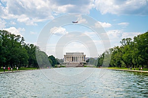 Lincoln Memorial in the National Mall, Washington DC. Lincoln Memorial on blue sky background and ducks swimming in the pond photo