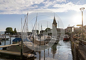Lindau harbor on Lake Constance with ships, houses, harbor entrance and cafes at summer