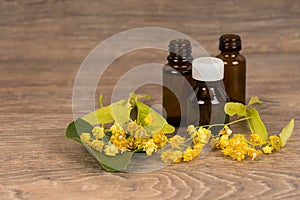 Linden blossom with brown bottle. Alternative medicine or folk healing concept