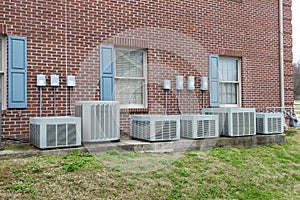 A Line Of Air Conditioners Outside A Commercial Building