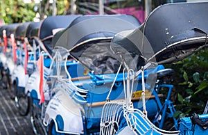 A line of becak handicap with blue color photo taken in yogyakarta indonesia photo