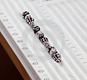 Line of black and pink beads