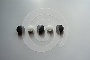 Line of black and white pills