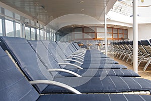 LIne of Blue Chaise Lounges on Deck of Ship