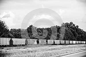 Line of Boxcars along a Highway