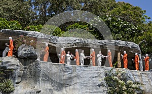 A line of Buddhist monk statues at the Golden Temple at Dambulla, Sri Lanka.