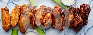 Line of buffalo chicken wings drenched in different sauces