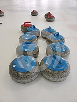 A line of curling stones on area ice