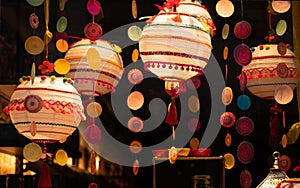 Line of decorative garlands hanging against a dark background.