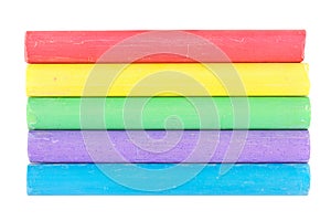 Line of different color chalks on white