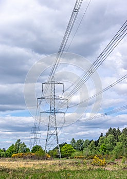 Line of electricity pylons in countryside