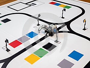 Line Following Robot is doing task to move from one point to another on the mat. Programmable robots