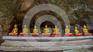 In-line golden Buddha statues in Khao Luang Cave - Phetchaburi, Thailand