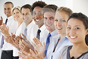 Line Of Happy And Positive Business People Applauding