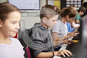 Line Of High School Students Working at Screens In Computer Class