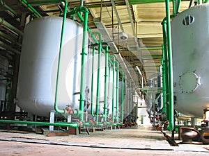 Line of industrial chemical tanks at power plant