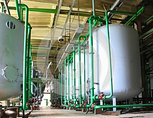 Line of industrial chemical tanks at power plant