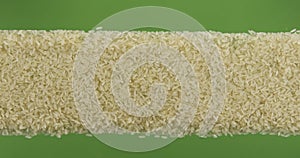 Line made from rice seeds top view. Slider shot. Isolated