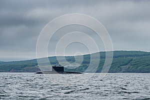 A line of modern russian military submarine cruisers in the row, northern fleet and baltic sea fleet in the open sea