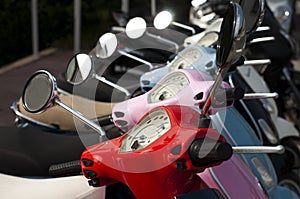 A line of mopeds/scooters